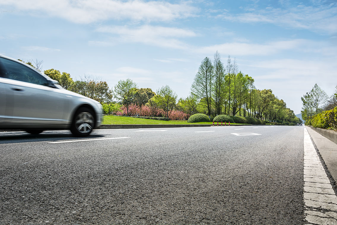 Car ride on road in sunny weather, motion blur